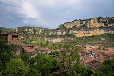 Top view cityscape of the picturesque town of Orbaneja del Castillo with a stormy sky, Burgos, Spain