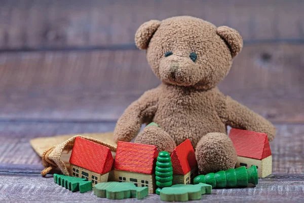 Plush bear and wooden toy