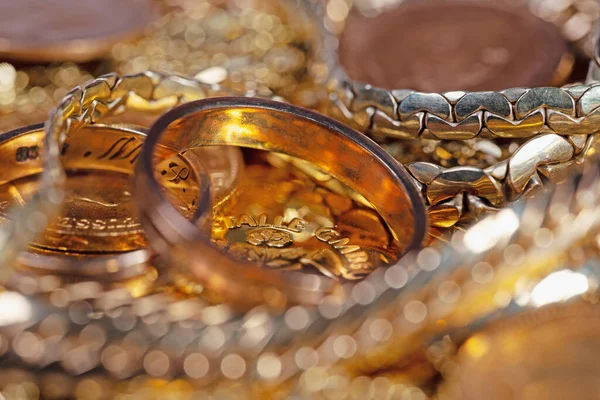 Gold jewelry, gold coins and gold bars in a close-up