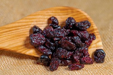 Dried cranberries on a wooden spoon