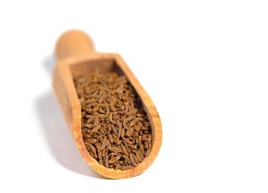 Cumin seeds on a spice scoop clipart