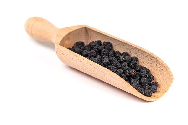 Dried aronia berries against a white background