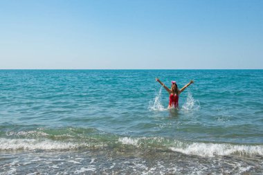 Deniz kıyısı Santa Sparkle: kırmızı mayo ve Santa Hat Delight. Yüksek kalite fotoğraf