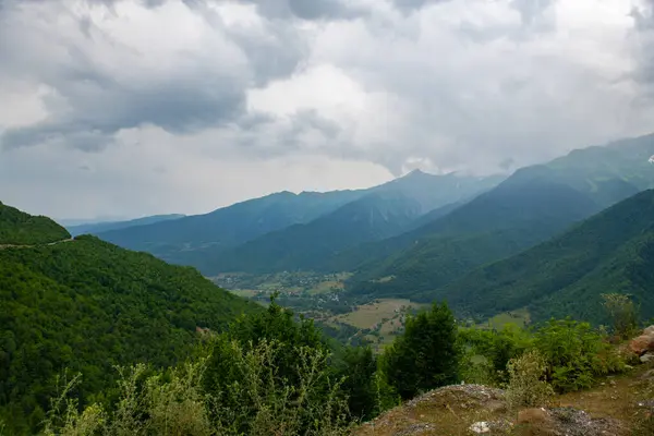 stock image Heavenly Canopy: Blue Skies Shelter the Green Mountain Peaks. High quality photo