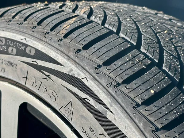 All-Season Tire Marked with M+S Logo: Rolling at the Four Seasons from Winter in Mountains to Summer