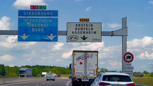 stock image Selestat, France - June 6 2024 : Highway A35 in Alsace, France, with road signs for Strasbourg, Entzheim, Obernai, Barr, Erstein, Benfeld, and Kogenheim on a clear day