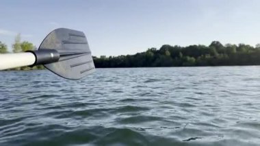 Sakin bir yaz gününde Serene Gölü 'ne damlayan bir kürek bıçağının yakın çekimi, Doğadaki Macera ve sükuneti ön plana çıkarıyor.