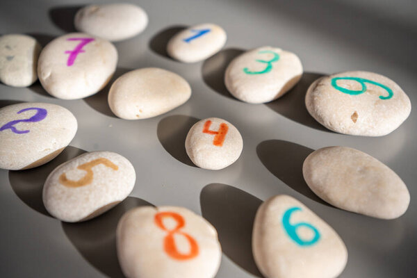 Colorful stones signed by numbers, an alternative method of children education. Number 4 in center. High quality photo