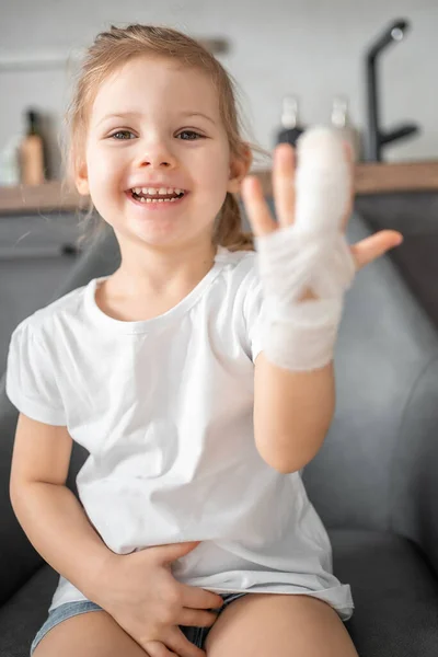 Little girl with broken finger at the doctors appointment in the hospital. High quality photo