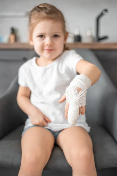 Little girl with broken finger at the doctor\'s appointment in the hospital. High quality photo