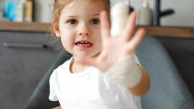 Little girl with broken finger at the doctors appointment in the hospital. High quality 4k footage