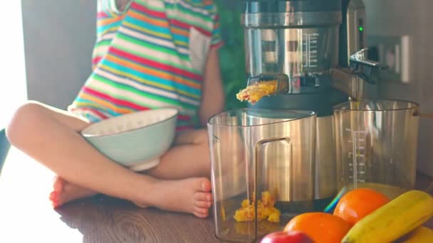 小女孩在家里厨房的桌子上做新鲜果汁 专注于果汁 高质量的4K镜头 — 图库视频影像