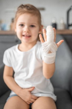 Little girl with broken finger at the doctors appointment in the hospital. High quality photo