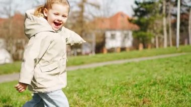 Mutlu küçük kız koşuyor ve Prag, Avrupa 'da güneşli bir günde bahar parkında eğleniyor. Yüksek kalite 4k görüntü