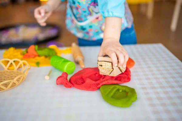 stock image A little girl playing with plasticine. Sensory development and experiences, themed activities with children, fine motor skills development. High quality photo