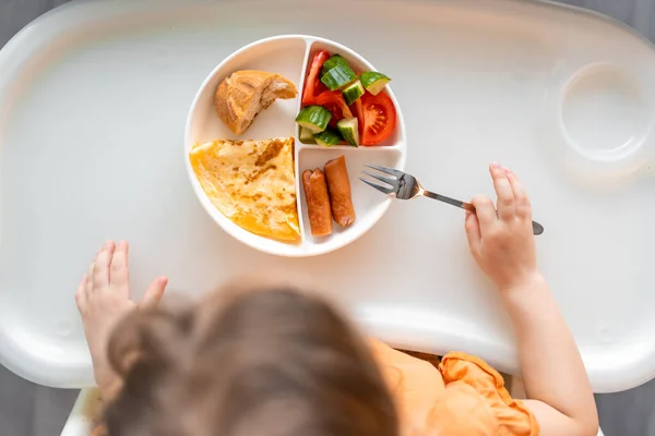 stock image Little girl have a balanced breakfast in home kitchen in the morning. High quality photo