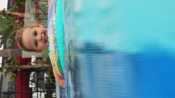 Happy Little Girl Swims Pool Summer Inflatable Ring Child Learning — Stock Video