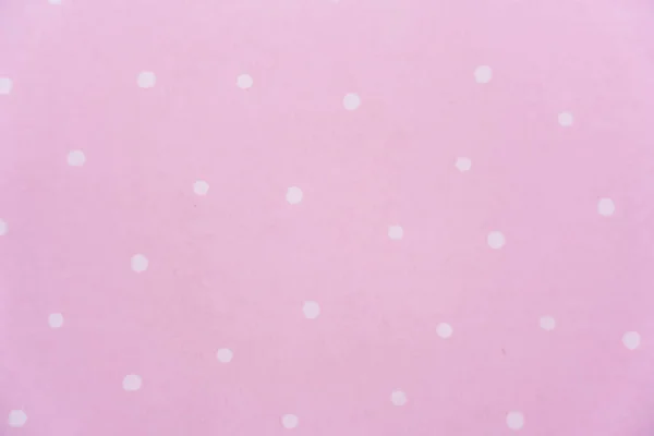 White polka dot on pink background. Paper pattern. High quality photo