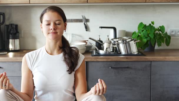 Young Woman Sitting Doing Meditation Background Dirty Dishes Kitchen Slowdown — Stock Video