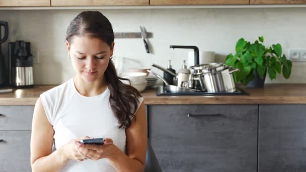 Молода Жінка Сидить Телефоном Тлі Брудного Посуду Кухні Сповільнюється Сповільнюється — стокове відео