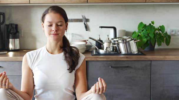 Giovane Donna Seduta Facendo Meditazione Sfondo Piatti Sporchi Cucina Rallentamento — Video Stock