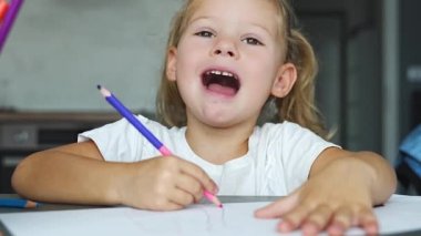 Küçük kız evde renkli kalemlerle resim çiziyor. - Evet. Yüksek kalite 4k görüntü
