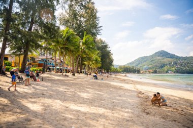 Phuket, Thailand - December 19, 2023: Close up view of a tropical sandy beach with people in Phuket island in the morning. High quality photo