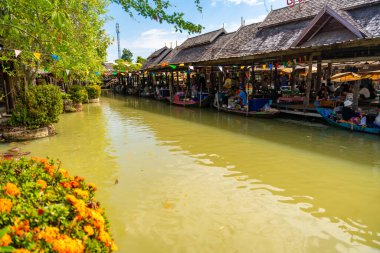Pattaya, Thailand - December 29, 2023: Floating open air market with small houses - shops on the pond in Pattaya, Thailand. High quality photo