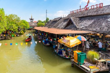 Pattaya, Thailand - December 29, 2023: Floating open air market with small houses - shops on the pond in Pattaya, Thailand. High quality photo