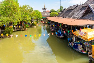 Pattaya, Thailand - December 29, 2023: Floating open air market with small houses - shops on the pond in Pattaya, Thailand. High quality photo