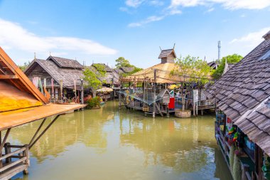 Pattaya, Thailand - December 29, 2023: Floating open air market with small houses - shops on the pond in Pattaya, Thailand. High quality photo