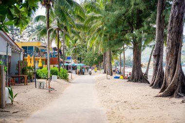 Phuket, Thailand - December 19, 2023: Close up view of a tropical sandy beach with people in Phuket island in the morning. High quality photo
