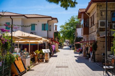 Side, Türkiye - 8 Mayıs 2024: Şehir merkezinin sokaklarında insanlar ve Side, Antalya 'da çarşı. Sokak manzaralı kafe, restoran, dükkan ve evler, Türkiye. Yüksek kalite fotoğraf