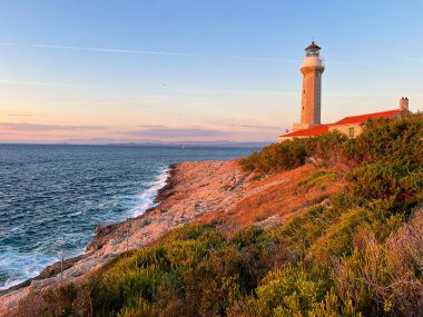 Lighthouse Stoncica at sunset light on island Vis, Croatia.  clipart