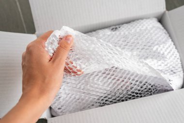 Kurye teslimat servisinin getirdiği malların paketlendiği, çevresel ambalaj konsepti olan güvenli taşımacılık için oyulmuş beyaz kağıt. Yüksek kalite fotoğraf