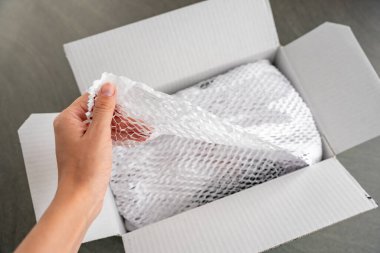 Kurye teslimat servisinin getirdiği malların paketlendiği, çevresel ambalaj konsepti olan güvenli taşımacılık için oyulmuş beyaz kağıt. Yüksek kalite fotoğraf