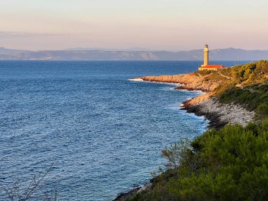 Lighthouse Stoncica at sunset light on island Vis, Croatia.  clipart