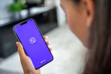 Prag, Çek Cumhuriyeti - 2 Mayıs 2024: İş yeri için mobil uygulama kullanan, ekranda Rakuten Viber uygulamasının logosu olan iPhone 'u tutan kadın. Yüksek kalite fotoğraf