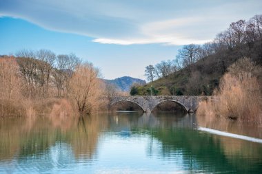 Arched bridge over Crnojevic river in small town near Skadar lake in Montenegro in winter time. High quality photo clipart