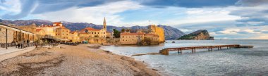 Budva, Montenegro - January 3, 2025: Budva, Montenegro, Balkans, Europe. Old town and mountains in background in winter time. High quality photo clipart