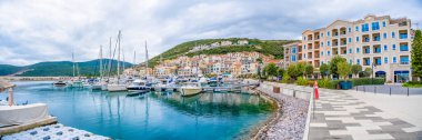 Lustica Bay, Montenegro - January 5, 2025: Architecture and luxury yachts in marina of Lustica Bay, Montenegro. High quality photo clipart