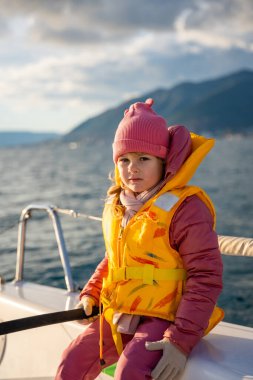 Karadağ 'ın Kotor Körfezi' nde eğitim sırasında, macera, özgürlük ve deniz sporlarını temsil eden bir yat kullanmayı öğrenen küçük bir kız. Yüksek kalite fotoğraf
