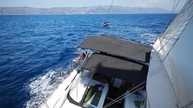 Direkten, Hırvatistan yakınlarındaki bir yelkenli yatının kokpitine kadar uzanan görüntü. Yelkencilik yaşam tarzı, özgürlük, takım çalışması ve denizde macera. Yüksek kalite 4k görüntü