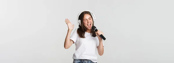Menina Sorridente Despreocupada Jogando Karaoke Cantando Microfone Com Fones Ouvido — Fotografia de Stock