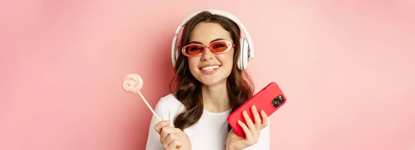 Stylish Young Woman Lolipop Cellphone Wearing Sunglasses Headphones Listening Music — Stockfoto