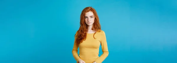 stock image Portrait of young beautiful ginger woman confident looking at camera. Isolated on pastel blue background. Copy space