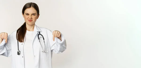 Disappointed Young Doctor Female Physician Pointing Fingers Grimacing Dislike Disapprove — Stok fotoğraf