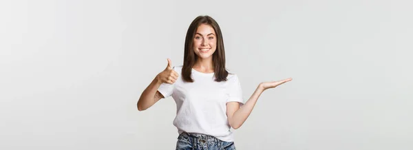 Satisfied Attractive Girl Holding Something Hand Showing Thumbs Approval — Stock Photo, Image