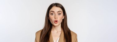 Close up portrait of surprised, amazed businesswoman, say wow, staring impressed at camera, fascinated face expression, white background.
