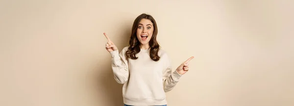 Cheerful Caucasian Woman Showing Directions Two Ways Pointing Sideways Variants — Stockfoto